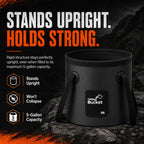 A premium black 5-gallon (20L) collapsible camping bucket stands perfectly rigid and upright on a dark rocky ground with mountains in the background. Bold distressed white and orange headlines read 'STANDS UPRIGHT. HOLDS STRONG.' Three orange hexagonal icons on the left highlight its key features: 'Stands Upright', 'Won't Collapse', and '5-Gallon Capacity', proving its heavy-duty reliability for outdoor overlanding.
