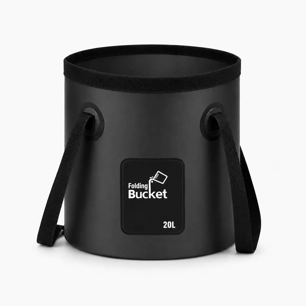 A professional product photography shot of the Terra Rinse 5-gallon (20L) collapsible camping bucket standing perfectly rigid and upright on a pure white background. The clean black heavy-duty overland bucket features reinforced webbing carry handles on both sides and a front square logo patch, showcasing its premium minimalist design for outdoor gear water storage.